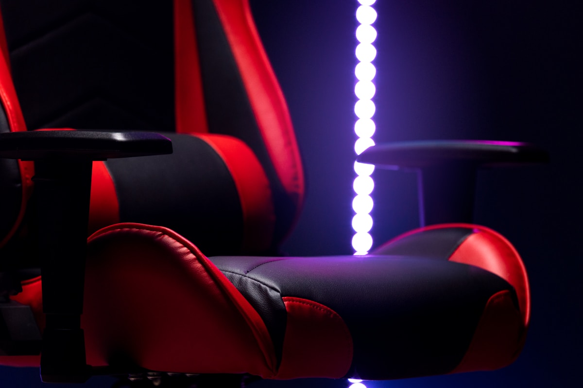 A red and black gaming chair with purple lights